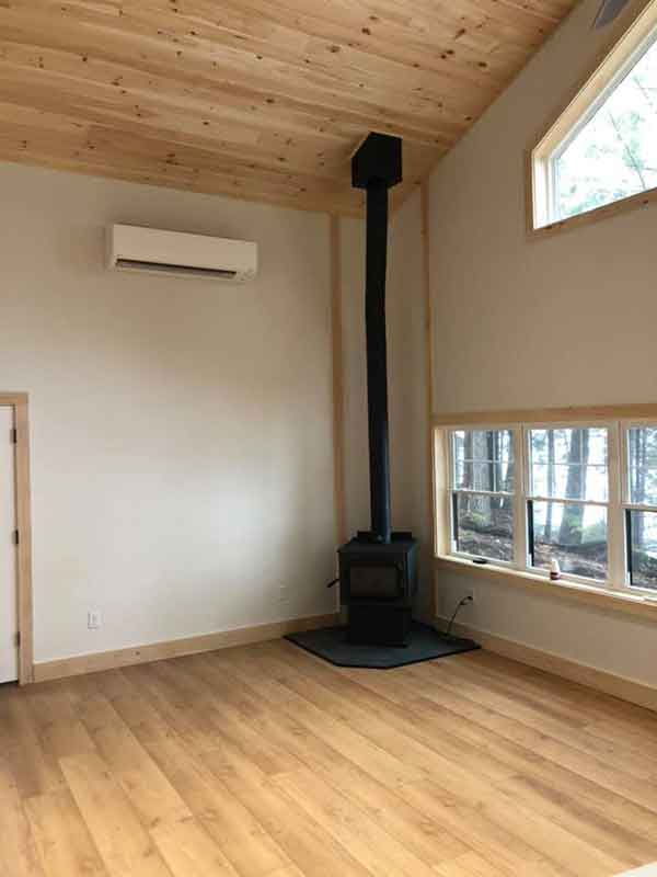 small black fireplace in corner of room with hardwood floors