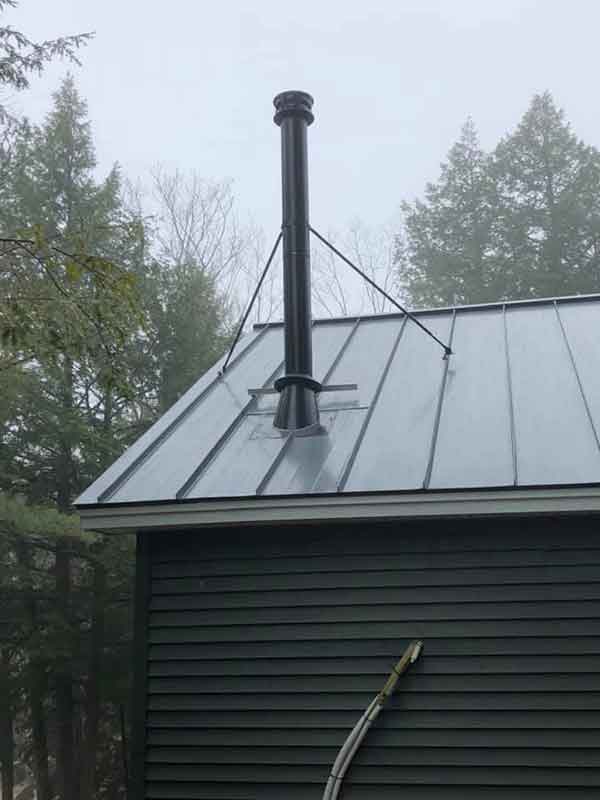 metal roof with metal chimney pipe coming out of it