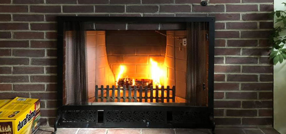 Fireplace burning with bricks on the side