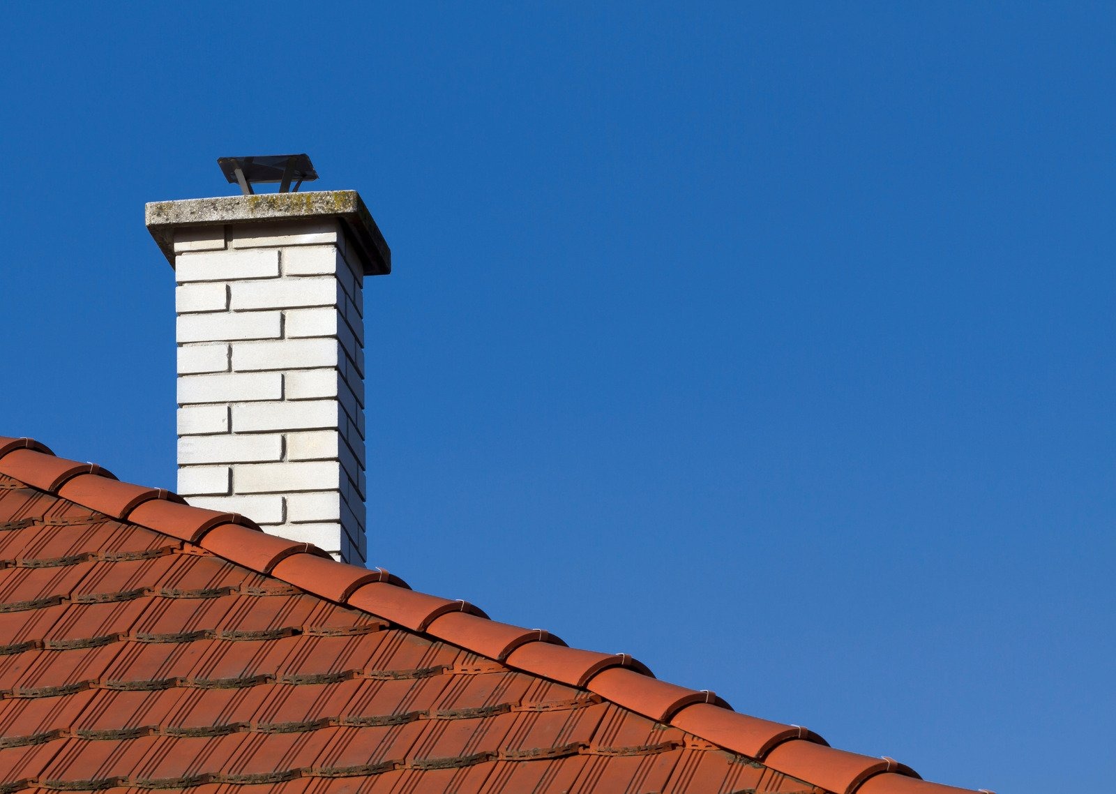 Frechette Chimney Sweeping technician applying water repellent sealant on a chimney.